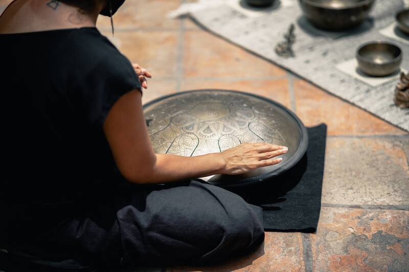 Close up of a girl playing a musical ethical instrument handpad